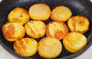 Roasted Cheese on a black pan.