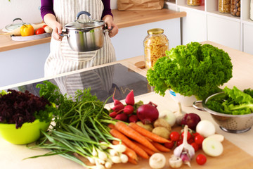 Young Woman Cooking in the kitchen. Healthy Food