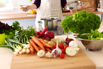 Young Woman Cooking in the kitchen. Healthy Food