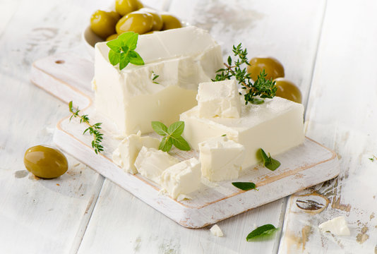 Feta cheese with olives and fresh herbs.