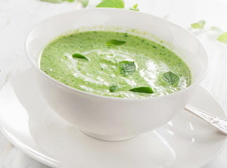 Creamy vegetable soup in  white bowl.