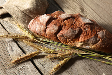 Freshly baked traditional bread on wooden table