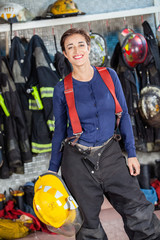Obraz premium Firewoman Holding Helmet At Fire Station