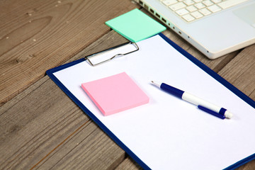 blank notebook on wooden table with pencils