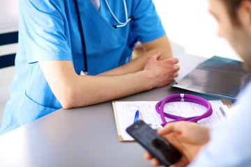 close up of patient and doctor taking notes