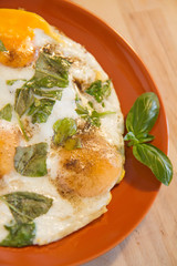 Fried eggs with basil