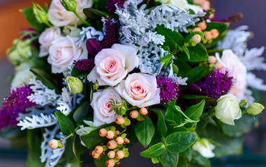 Bouquet of pink roses in the bunch with different decorations.