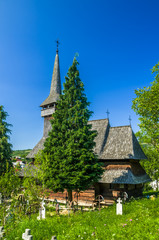 Fototapeta na wymiar Traditional wooden church in Maramures area, Romania. Old wooden church in Poienile Izei village, Maramures county, northern Romania