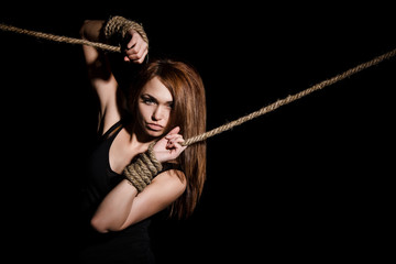 Beautiful young woman with tied arms