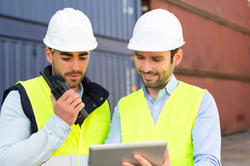 Two young attractives dockers working on the dock