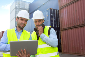 Dock worker and supervisor checking containers data on tablet