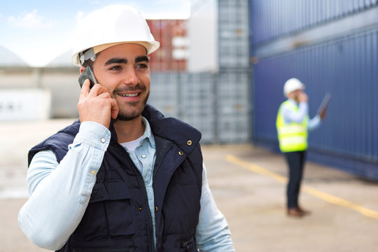 Young Attractive docker using mobile phone at work