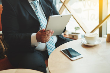Working in coffee shop. Close up view cropped image of thoughtfu