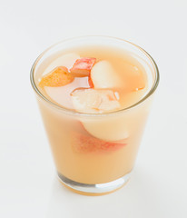 glass of pear juice with cut pieces