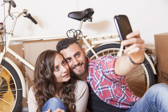 pretty young couple take a selfie after moving