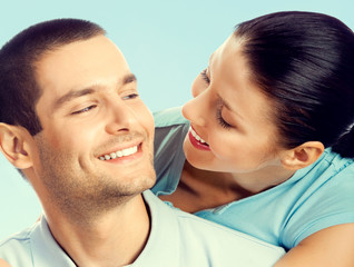 Cheerful young couple, over blue