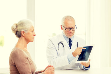 Fototapeta premium senior woman and doctor with tablet pc