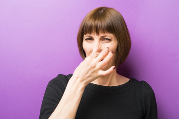 portrait of a woman bad smell purple background