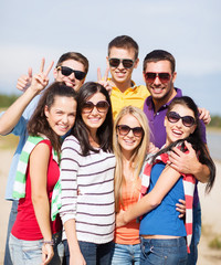 group of happy friends having fun on beach