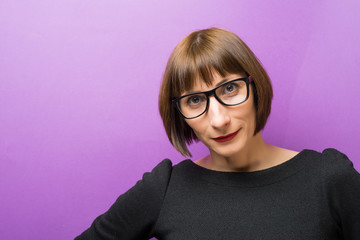 portrait of a woman with glasses, purple background