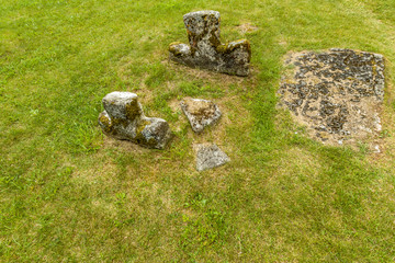 Half-sunken crosses mark forgotten graves