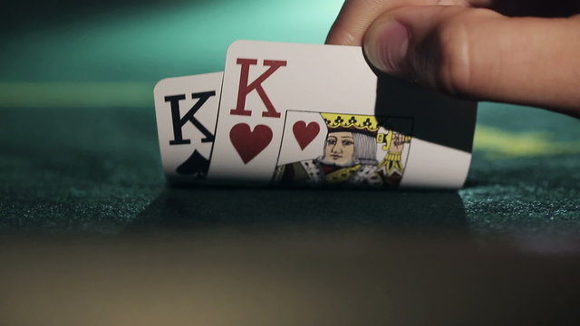 Poker player shows his pair hand two kings