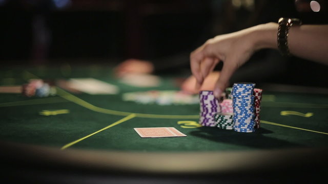 Poker player shows his good pair hand for win two aces and doing bet