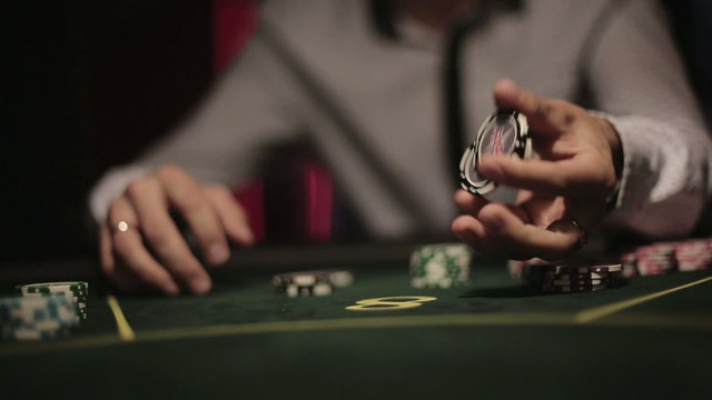 Casino, poker: Player shuffles chips famously. Close up