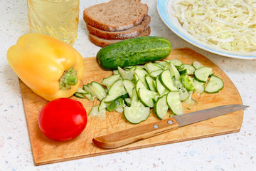 Fresh salad ingredients on kitchen table.