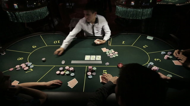 Casino, poker: Group of people in poker club gambling at poker card table. Time lapse