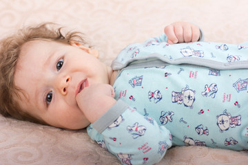 Beautiful baby with a lovely toys.The child in the crib
