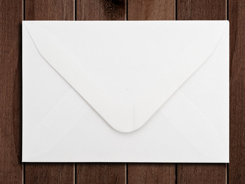 White envelope on a wooden surface.