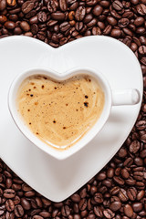 white coffee cup heart shaped with cappucino