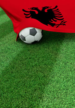 Soccer ball and national flag of Albania,  green grass