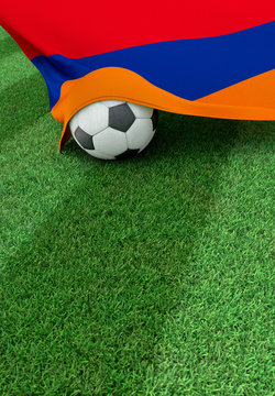 Soccer ball and national flag of Armenia,  green grass