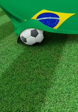 Soccer ball and national flag of Brazil,  green grass