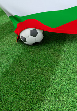 Soccer ball and national flag of Bulgaria,  green grass