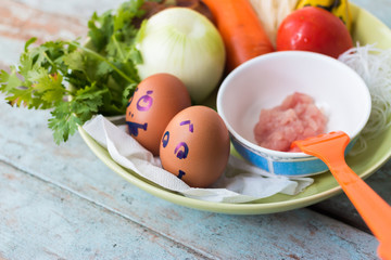 Fresh vegetables, eggs and pork chops. On blue wooden