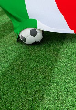 Soccer ball and national flag of Italy, green grass