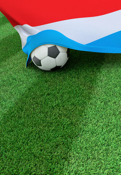 Soccer ball and national flag of Luxembourg,  green grass