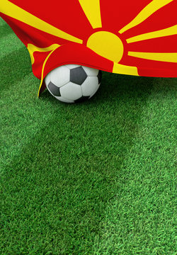 Soccer ball and national flag of Macedonia,  green grass