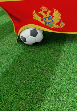 Soccer ball and national flag of Montenegro,  green grass