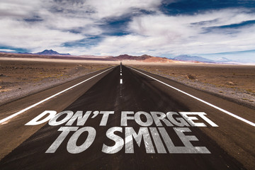 Don't Forget to Smile written on desert road