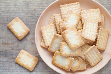Mini coconut biscuit in wood plate on wood table background