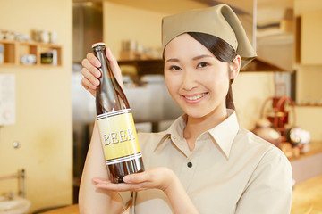 瓶ビールを持つ飲食店の店員