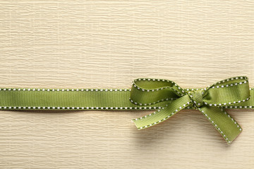 Ribbon bow on golden background