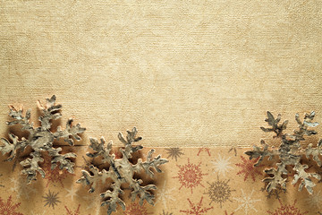 Wooden snowflake on golden background