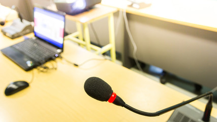 Black conference microphone and computer used for meetings and t