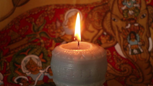 Close up of Mystical and Magical looking Burning Candle Wick & Flame (Static) against an exotic background.