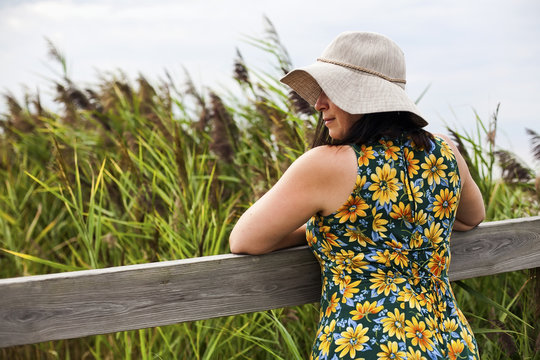 Summertime woman in florall sundress and hat